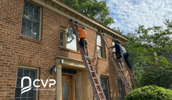 Men installing the windows in a house