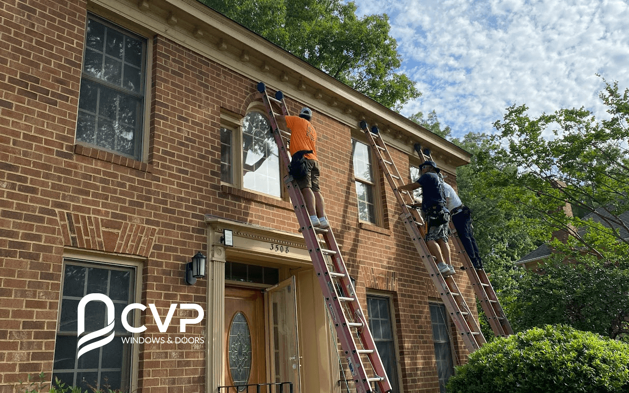 Men installing the windows in a house