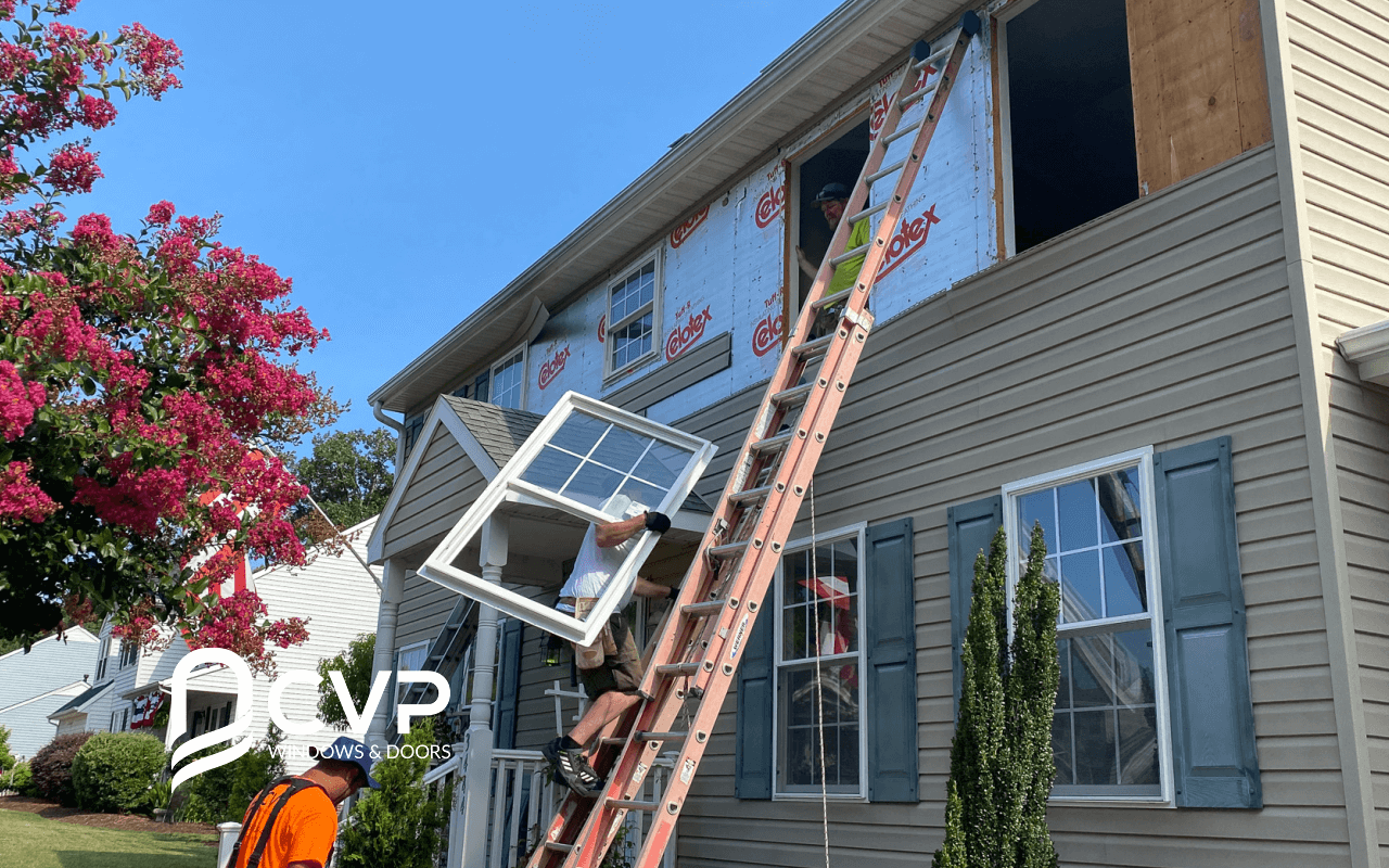 Men climbing the ladder by holding replacement windows